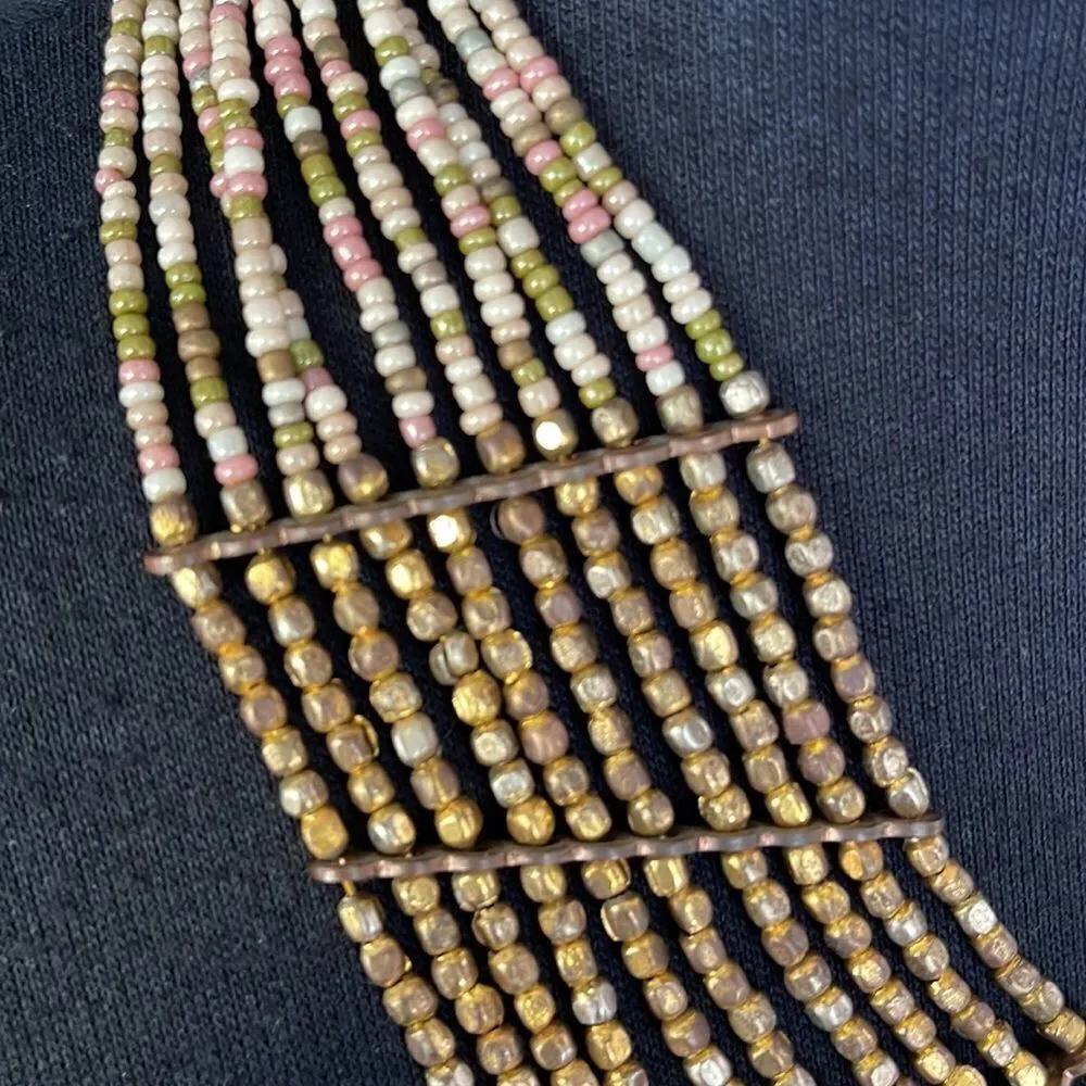 Multi strand bronze and pastel bead necklace.